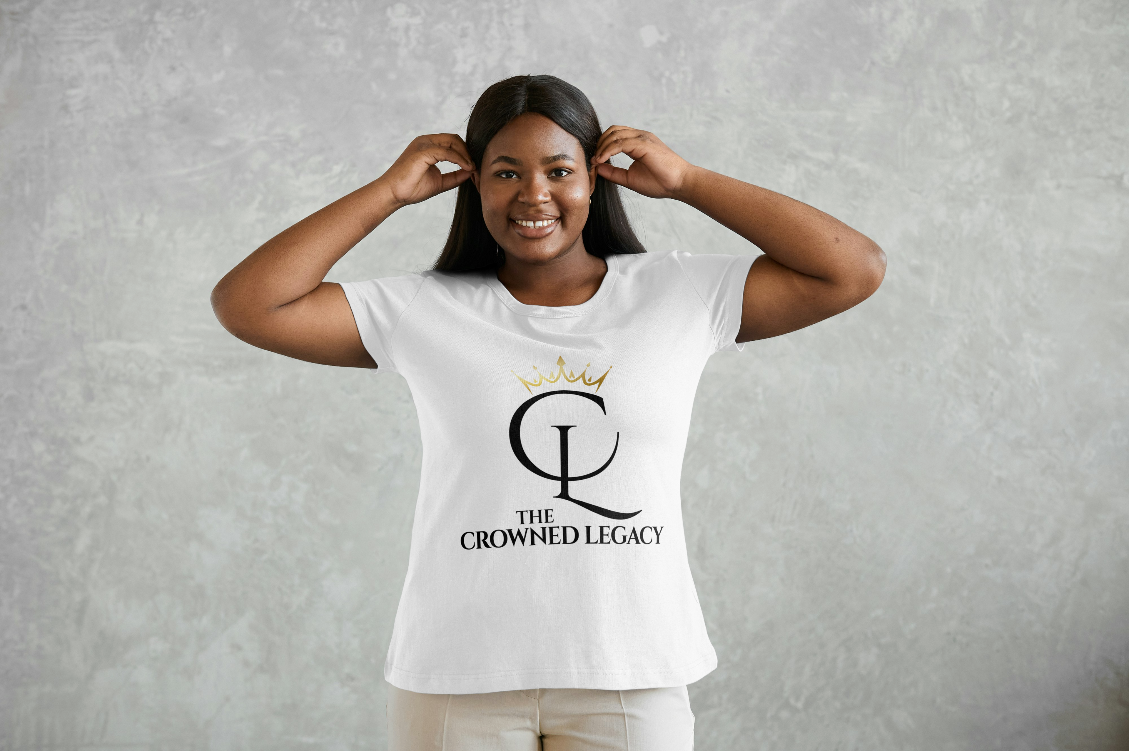Black Woman with a white tshirt with the logo of Crowned Legacy as the design